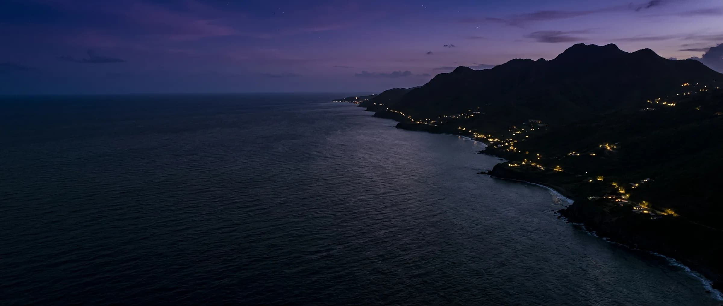 Aerial view of a Caribbean coastline at twilight